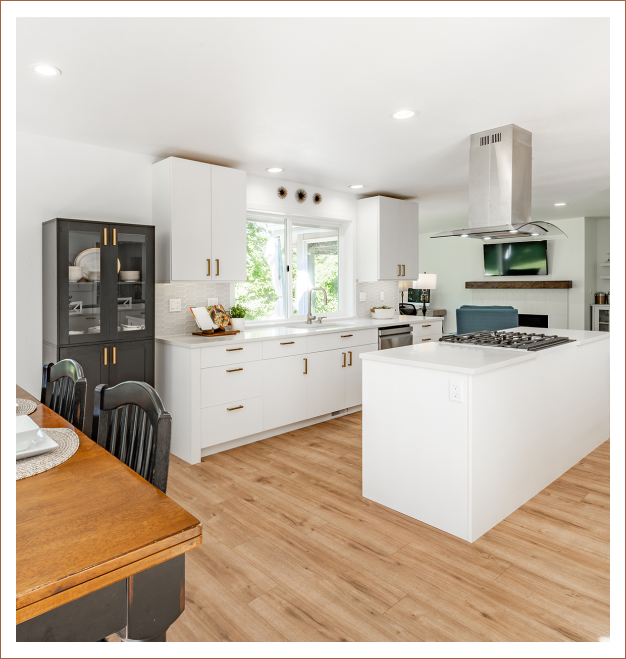 Modern kitchen with island and dining table.